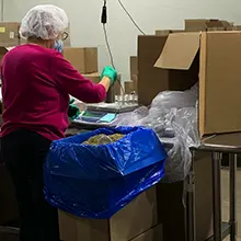 Worker weighing out items for packaging