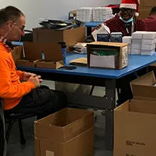 Workers packaging up items