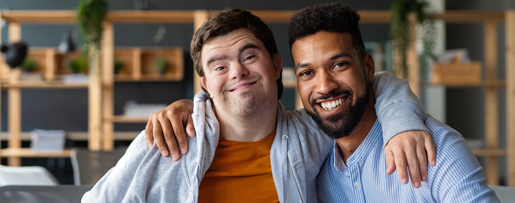 Two people with their arms around each other's shoulders