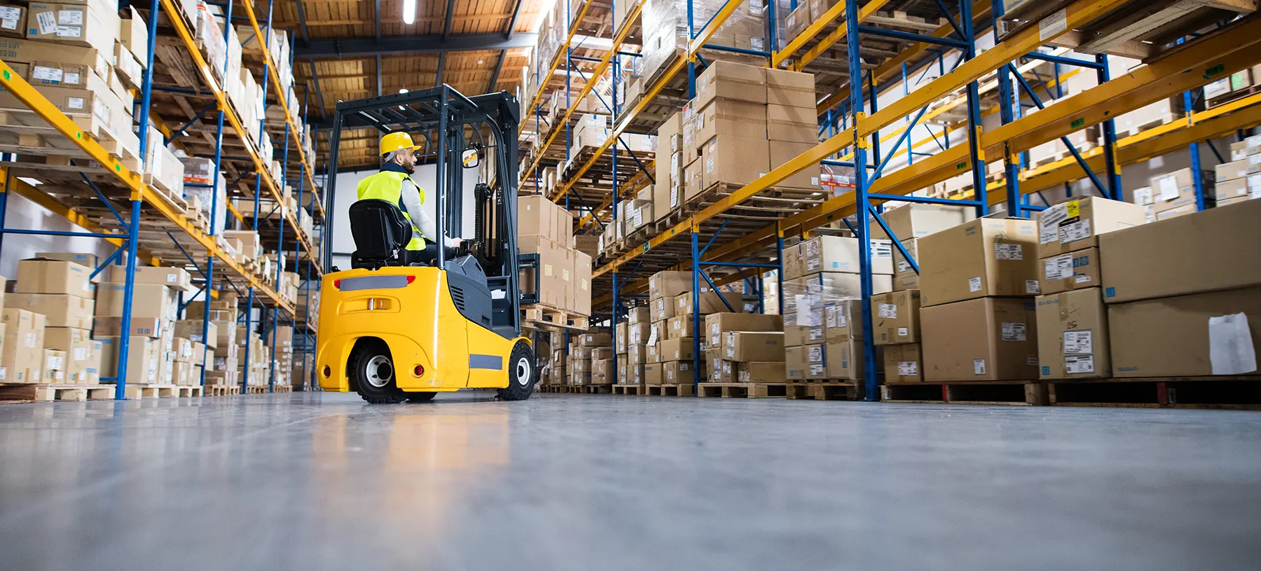 Person driving forklift in warehouse