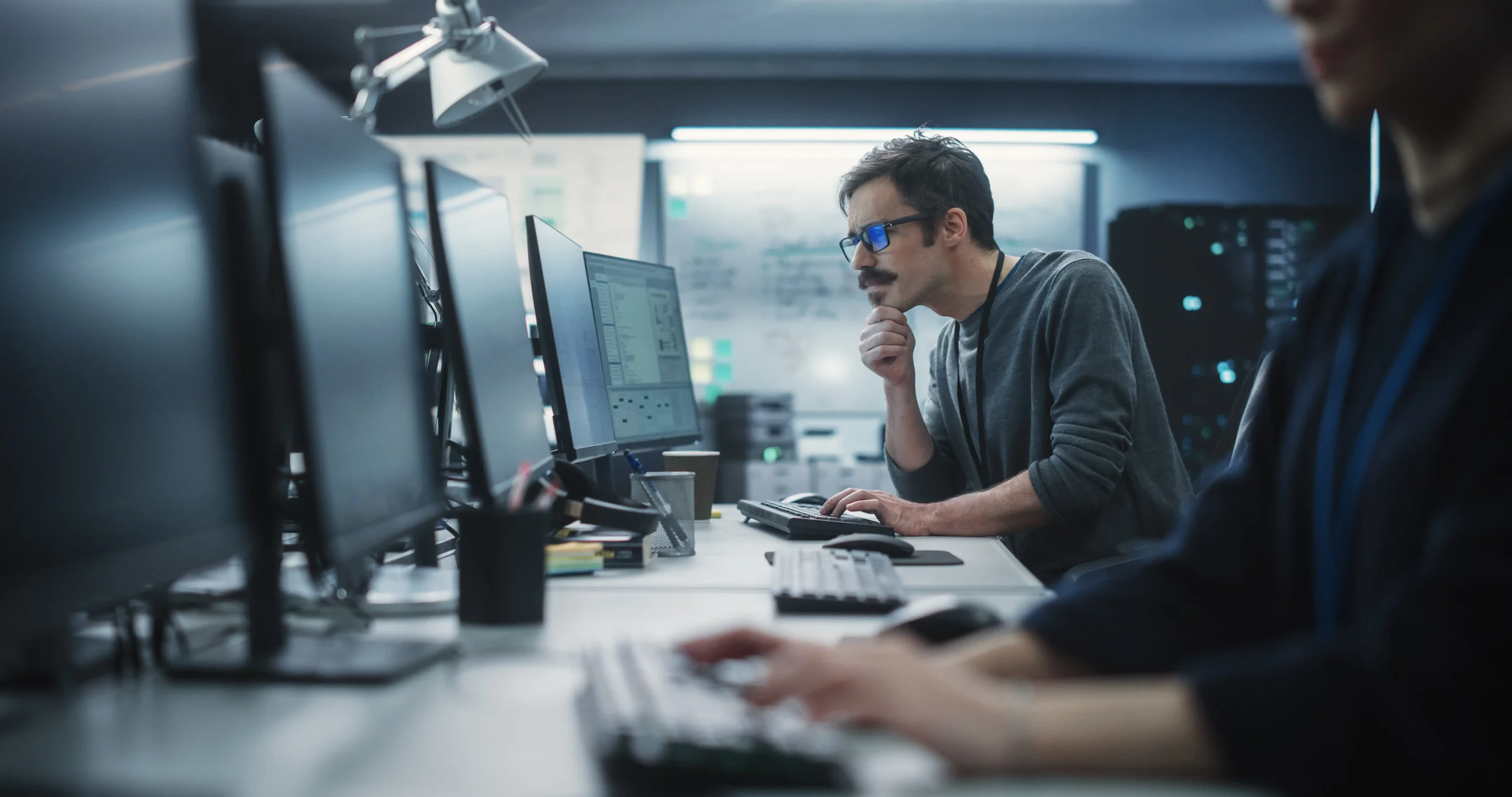 Row of workers sitting at their computers in a computer lab