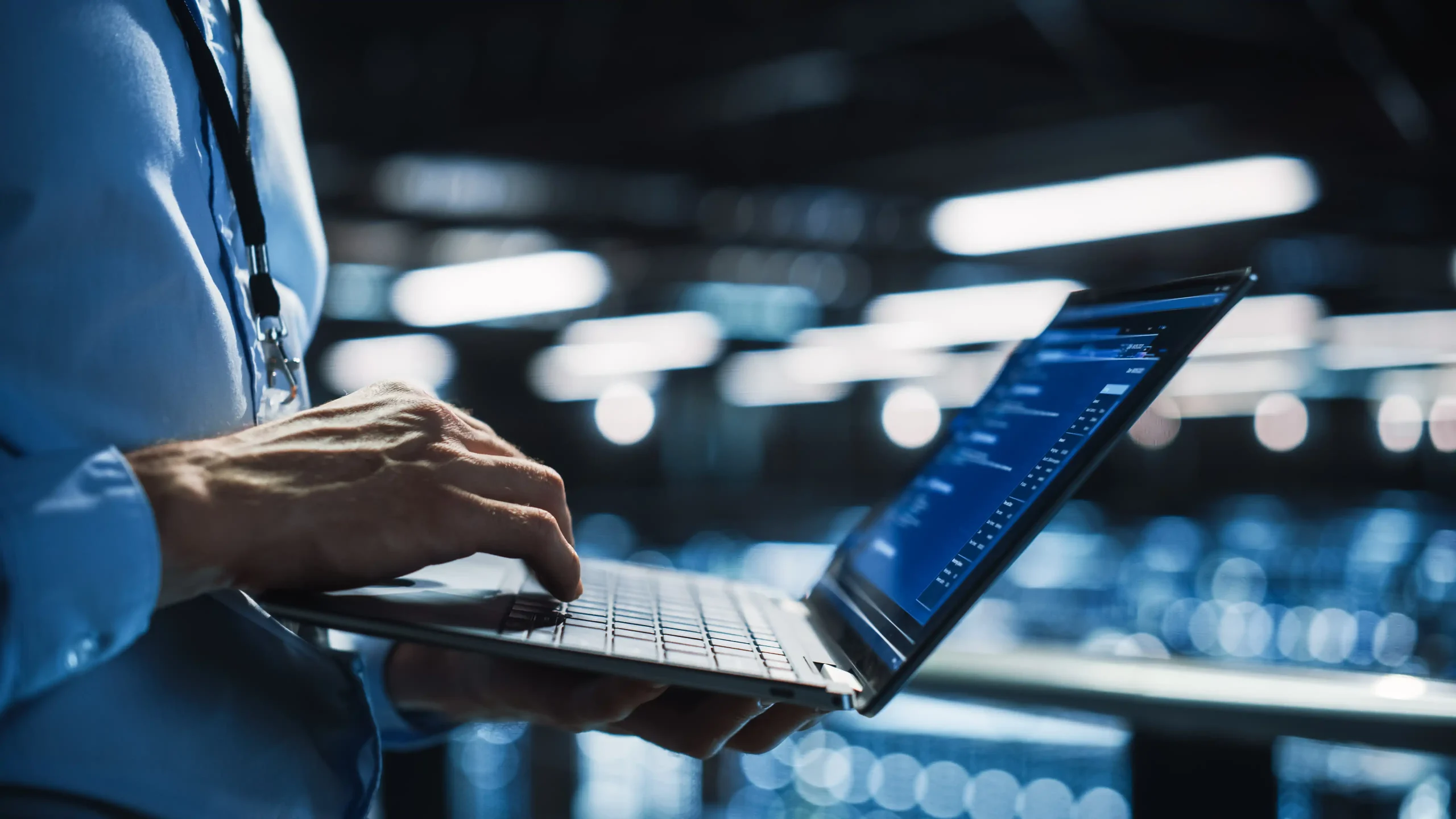 Person standing in a computer lap, using a laptop
