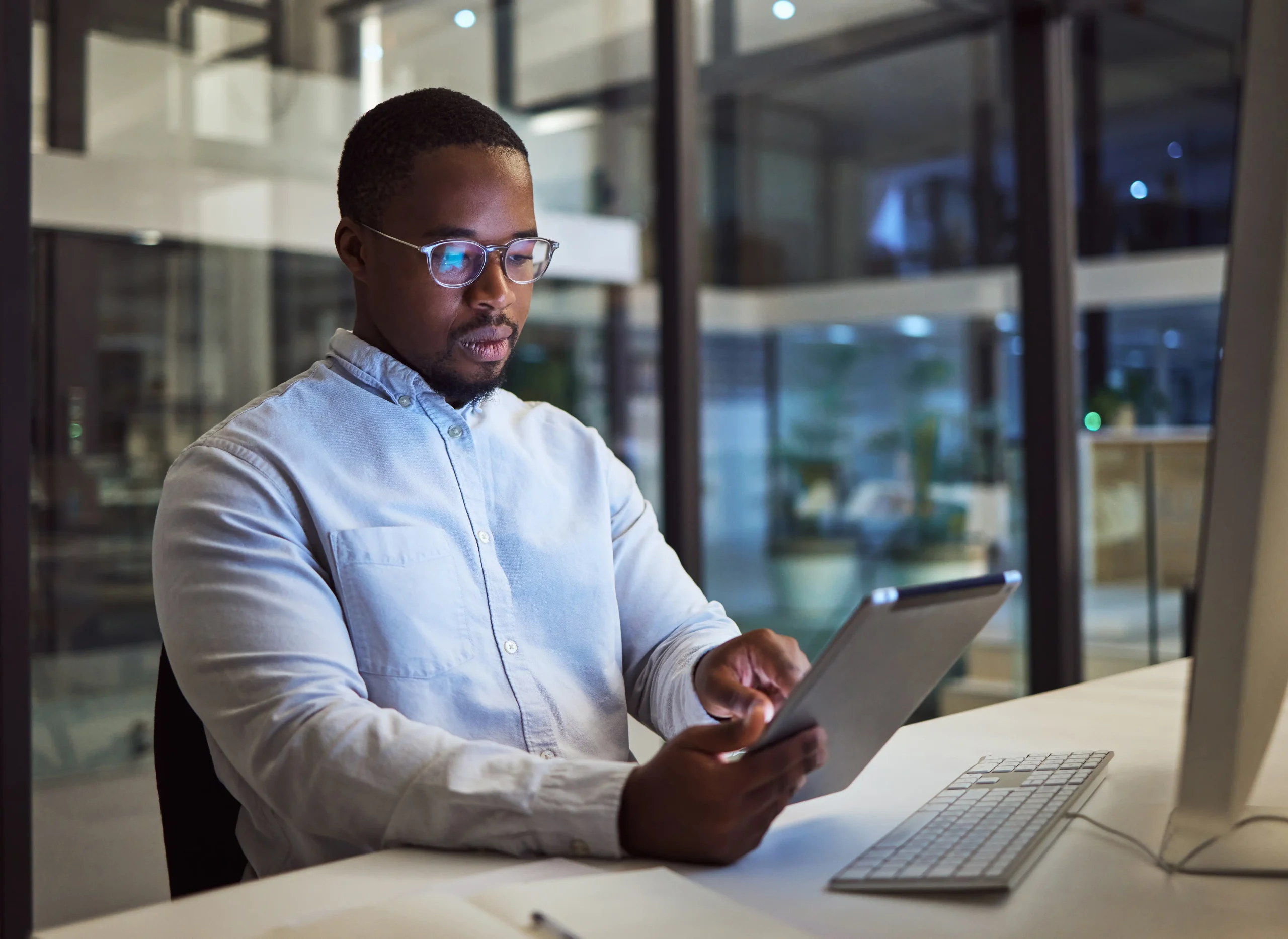 Business professional sitting at their desk, working on a tablet