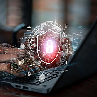 Person typing at a laptop, a projected image of a shield with a lock hovers over the keyboard