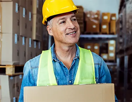 Warehouse worker carrying a box